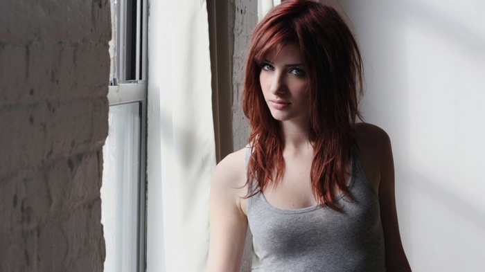 Susan Coffey with red hair by the window