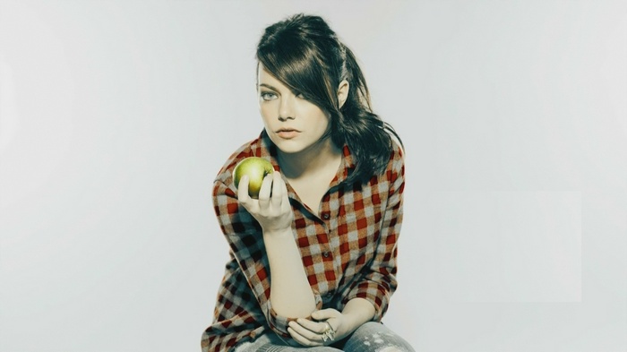 Emma Stone holding a green apple