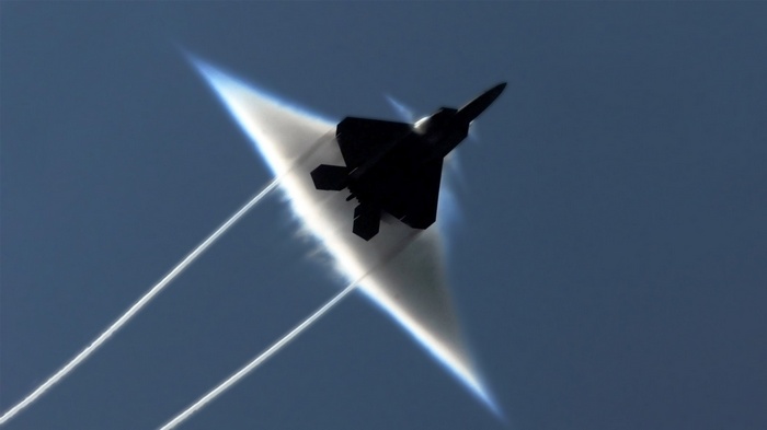 F-22 Raptor jet creating a vapor cone