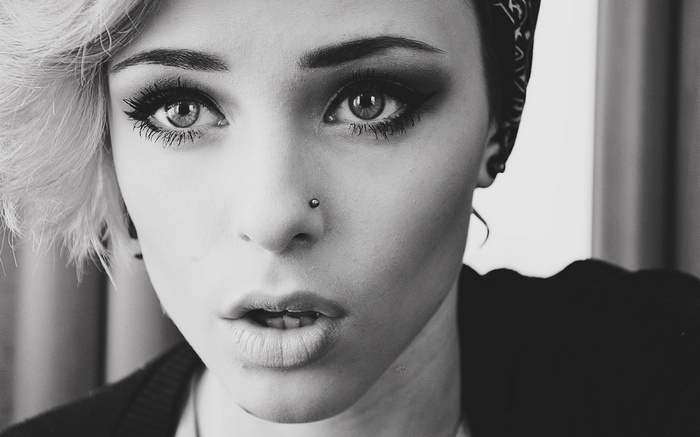 Monochrome portrait of a woman with nose piercing
