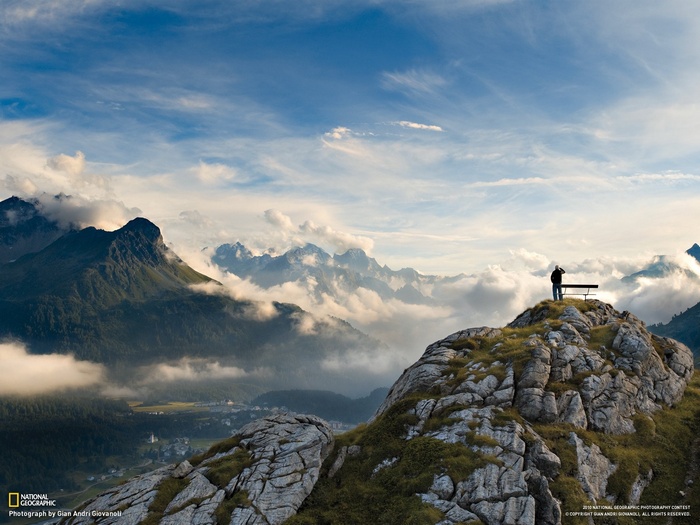 Man on a mountain overlooking the Alps