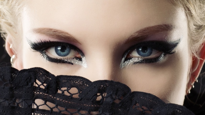 Woman with blue eyes and dramatic makeup