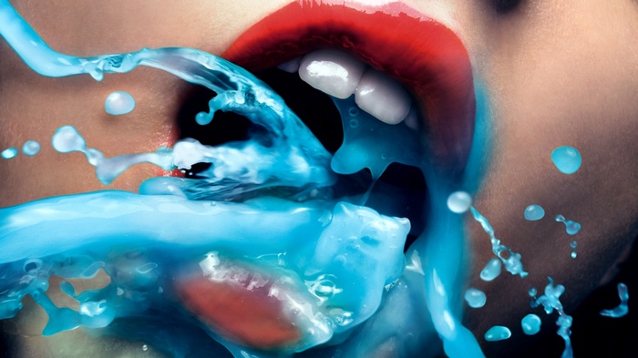 Woman with red lips and blue liquid splashing