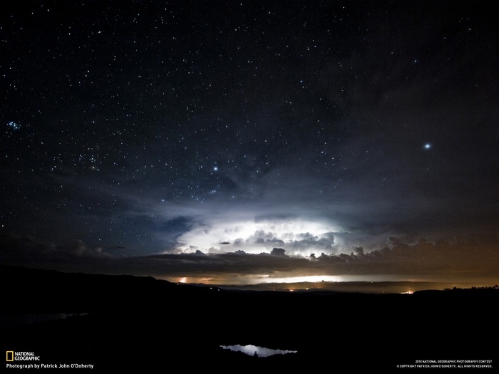 Night sky with stars and lightning storm
