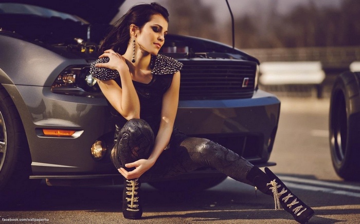 Woman posing with a Ford Mustang