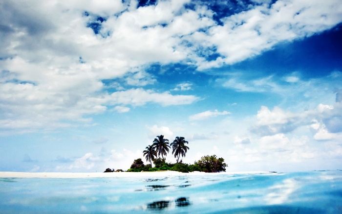 Tropical island with palm trees and clouds