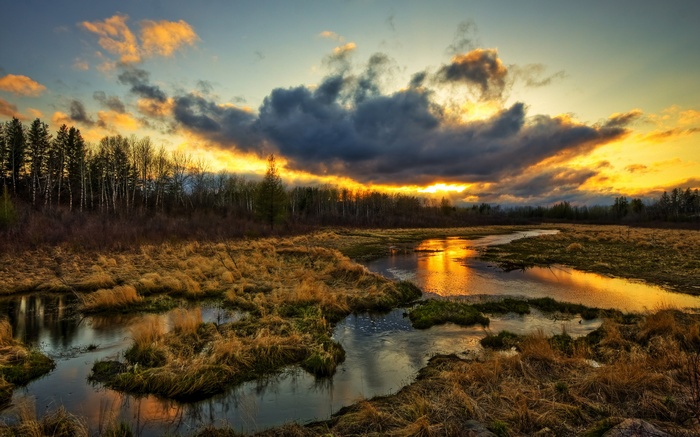 Sunset over a marshy landscape with a winding river
