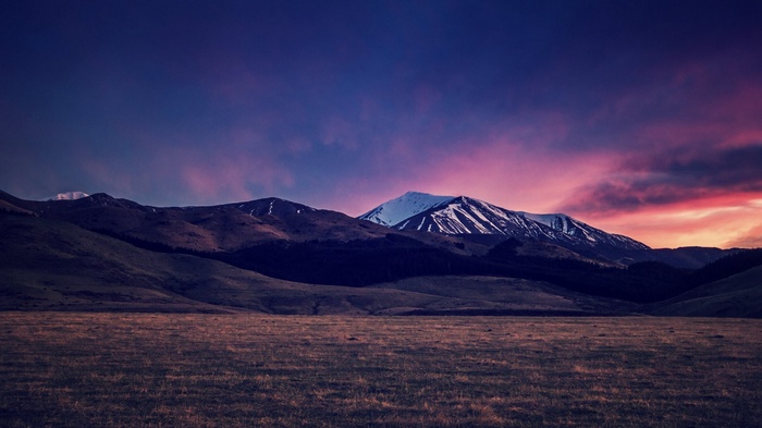 Mountains under a colorful twilight sky