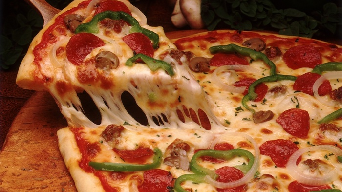 A slice of pepperoni pizza with melted cheese