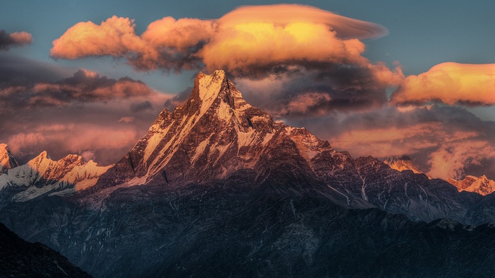 Machhapuchhre mountain in Himalayas during sunset with clouds
