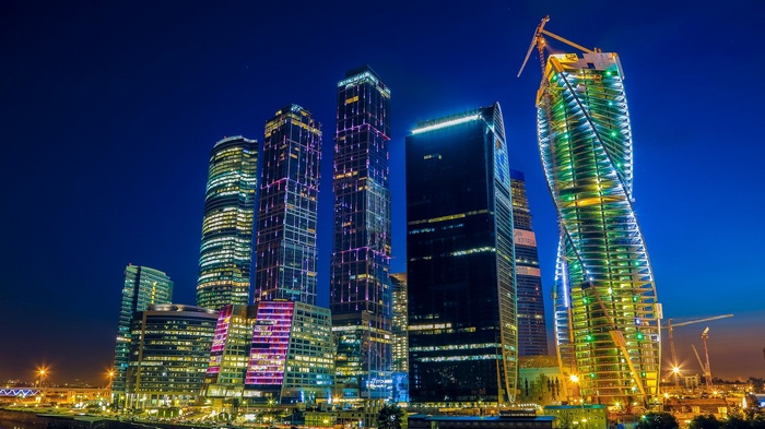 Moscow cityscape at night with illuminated skyscrapers