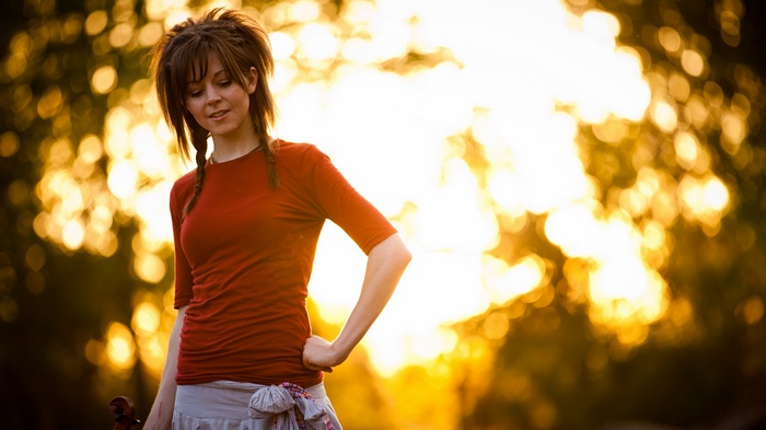 Lindsey Stirling with violin in golden hour light
