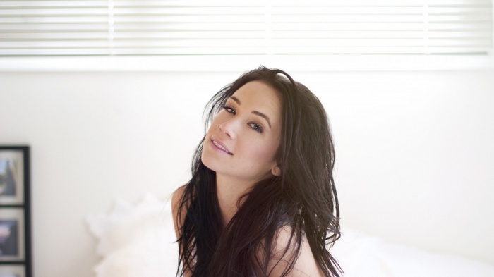 Megan Lyn with long dark hair and nose piercing