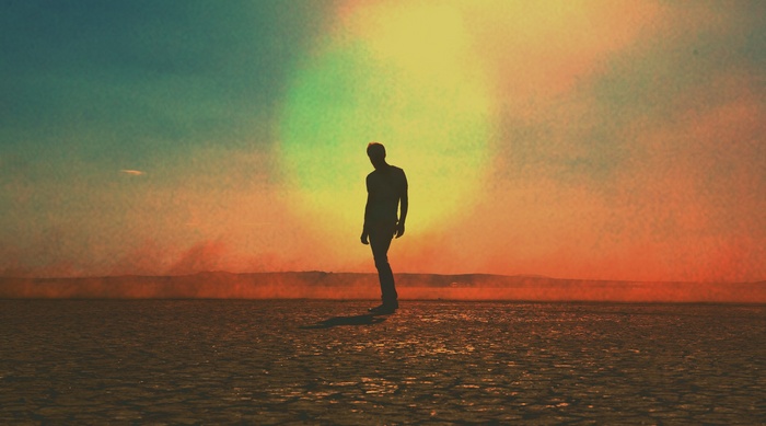 Silhouette of a man in the desert at sunset