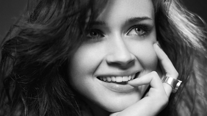 Alexis Bledel smiling with finger on lips
