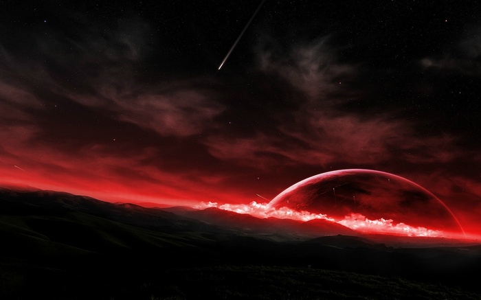 Red planet and comet over dark landscape