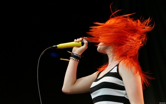 Hayley Williams of Paramore singing with red hair