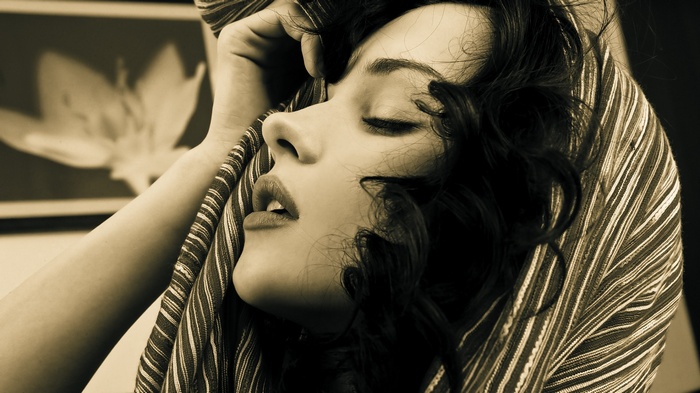 Katie Fey with curly hair and closed eyes