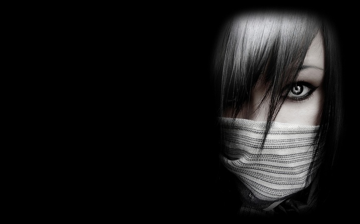 Woman with dark hair and scarf covering face