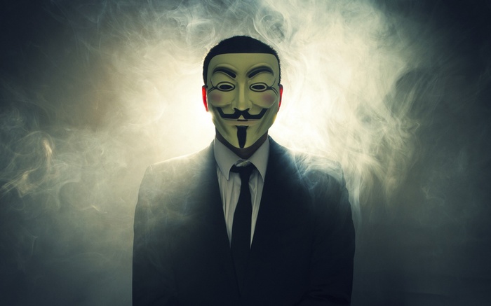 Man in Anonymous mask and suit in smoke