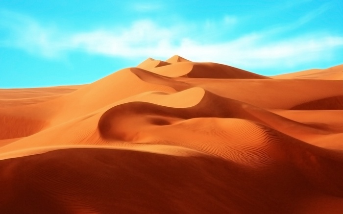 Desert dunes in Egypt under a blue sky