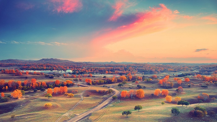 Autumn landscape with colorful trees and rolling hills