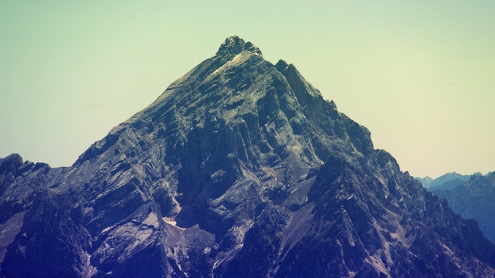 Majestic mountain peak under a pale sky