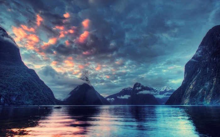 Milford Sound with dramatic clouds and water reflections