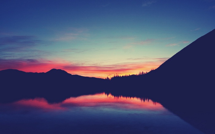 Mountains and lake at sunset with colorful sky