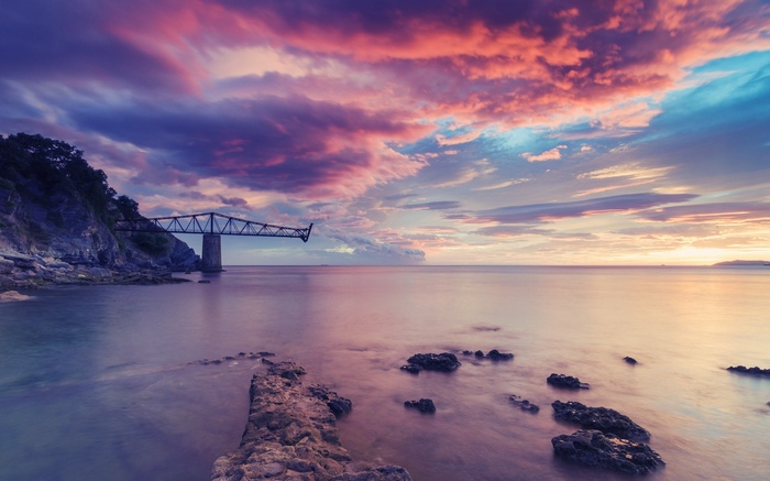 Bridge over the sea at sunset