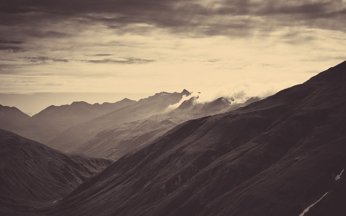 Misty mountains under a cloudy sky