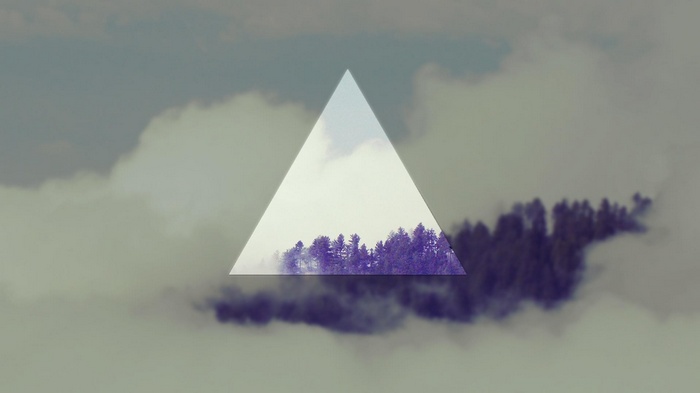 Triangle over misty forest and clouds
