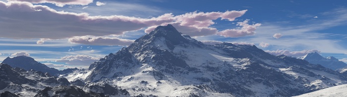 Snow-capped mountains under a cloudy sky