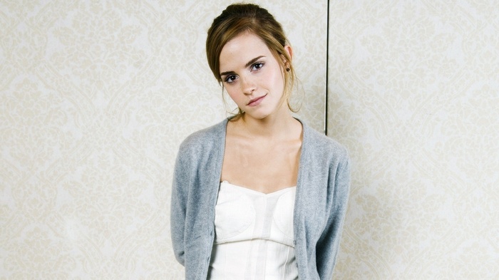 Emma Watson wearing a grey cardigan and white top