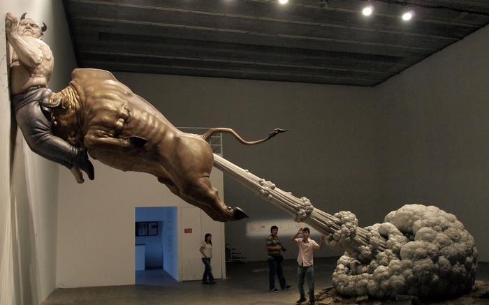 Sculpture of a man and a bull in a museum