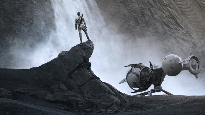Oblivion: Man standing on cliff near waterfall and spaceship