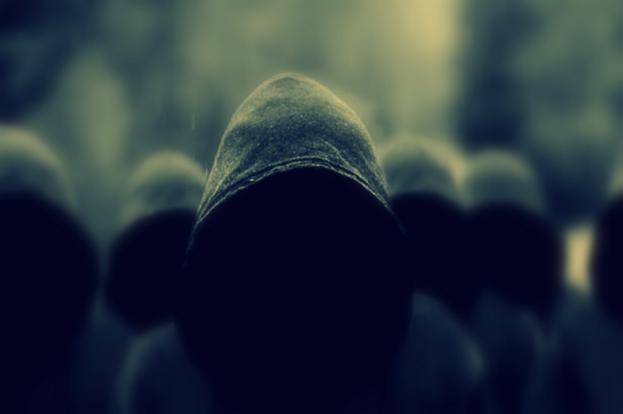 Group of people wearing dark hoods