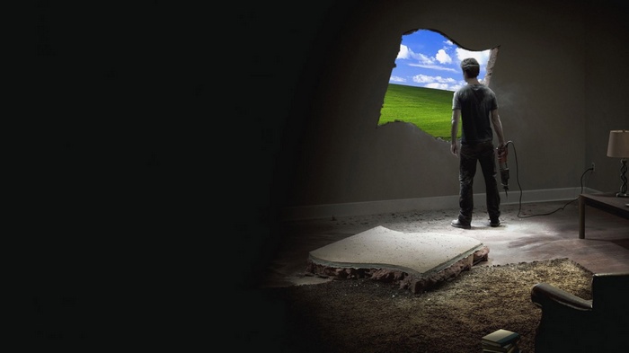 Man breaks hole in wall to reveal Windows XP landscape