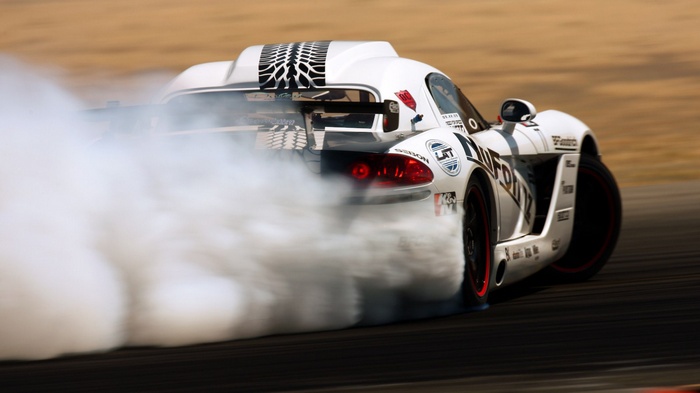 White Dodge Viper drifting with smoke