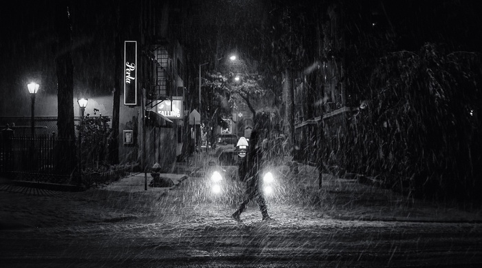 Person walking in the rain at night in the city