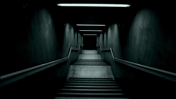 Dark underground stairs with fluorescent lights