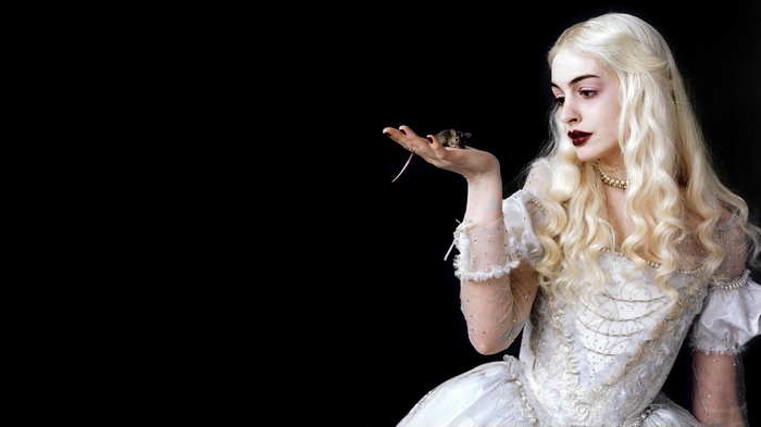 Anne Hathaway as the White Queen holding a mouse