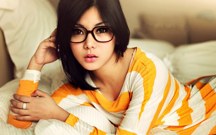 Asian woman with glasses wearing striped shirt