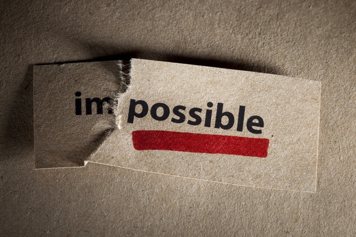 Torn paper with the word impossible