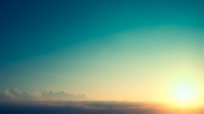 Sunlight over clouds at sunset