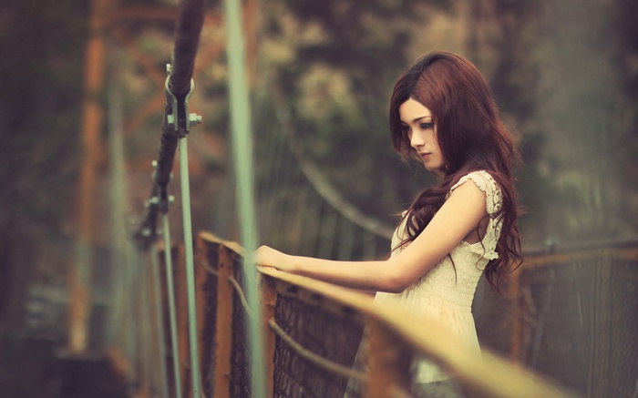 Woman with long hair on a bridge