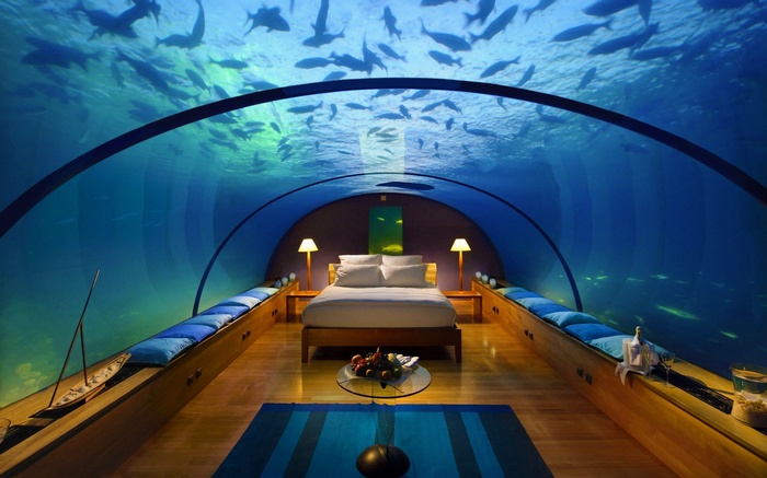 Underwater hotel bedroom with fish swimming above