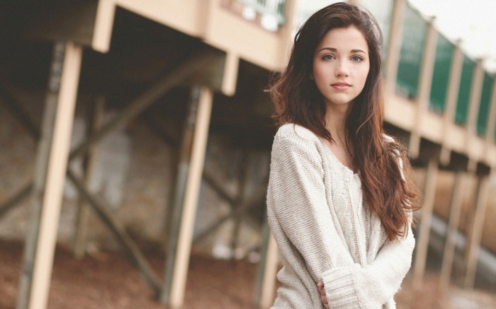 Emily Rudd wearing a sweater outdoors