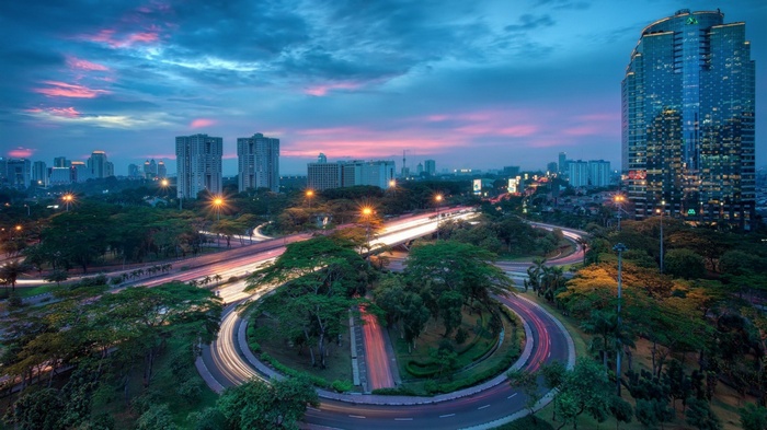 Jakarta cityscape with highway interchange at dusk
