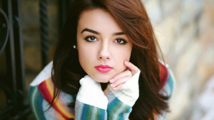 Young woman with brown hair and pink lips